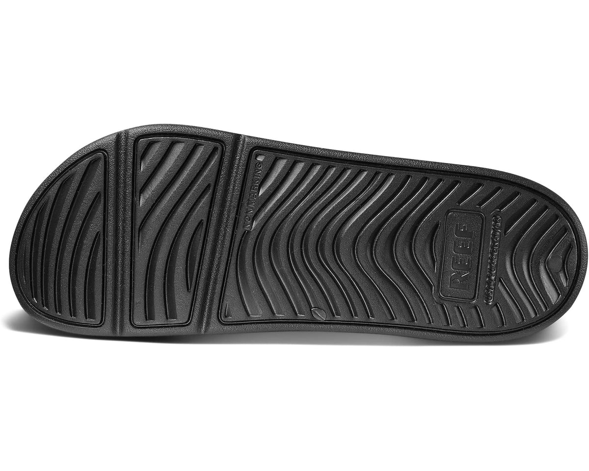 Men's black REEF slide sandals outsole with deep tread and embossed logo