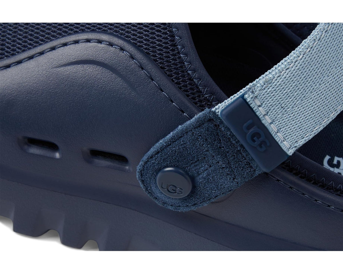 Men's UGG Peakmod shoe detail: dark navy leather panel, light blue strap, logo