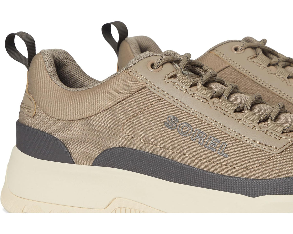 Men's SOREL sneaker detail view with khaki laces, stitched overlays, and “SOREL” logo