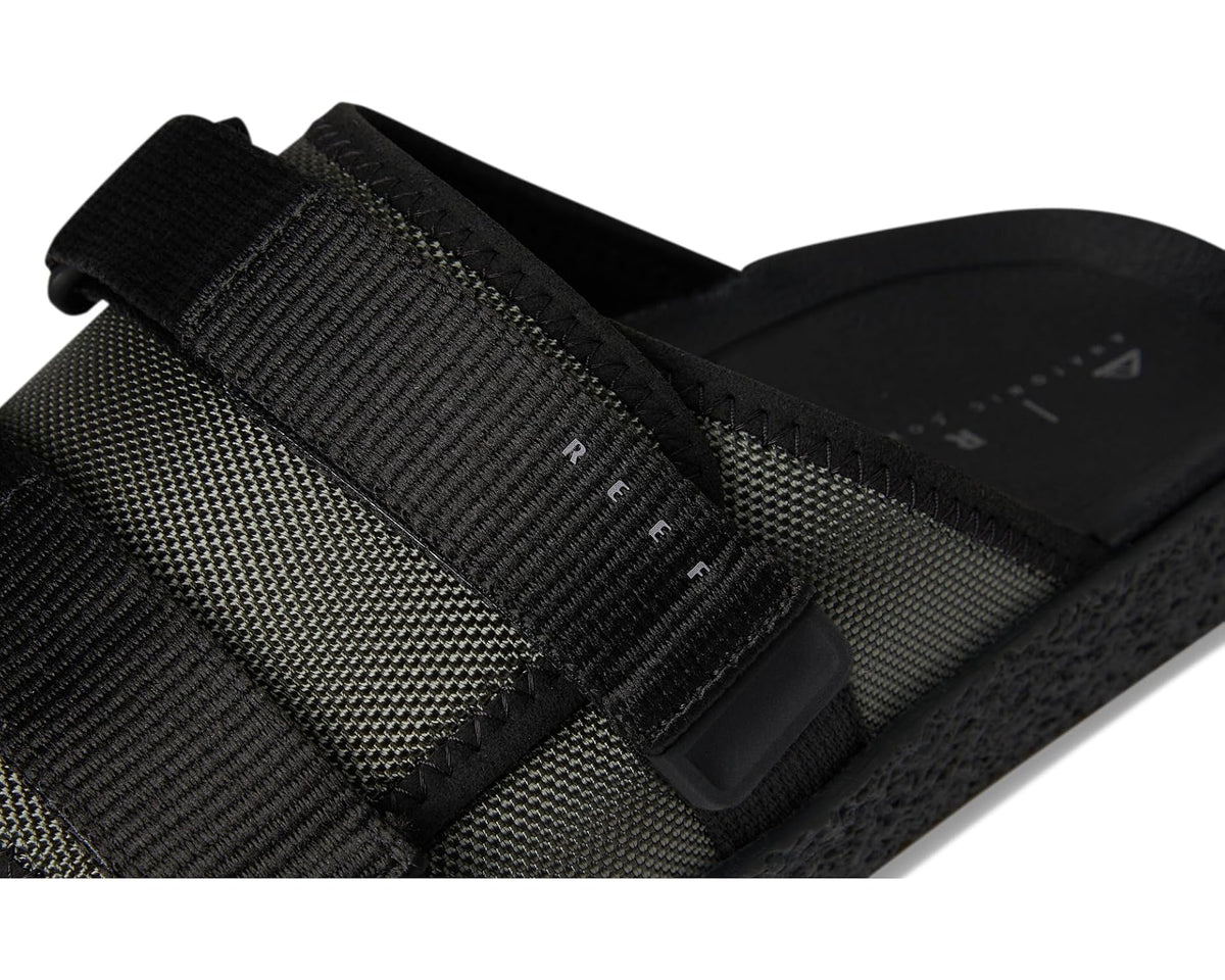 Close-up of olive and black slide sandal straps with molded buckle details