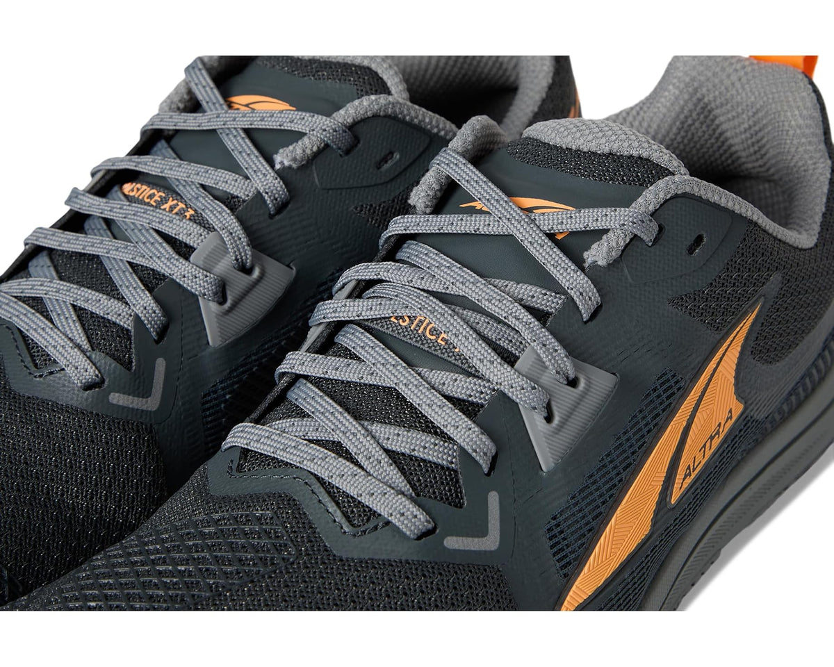 Men's ALTRA running shoe lace-up close-up, dark gray upper with orange branding accents.
