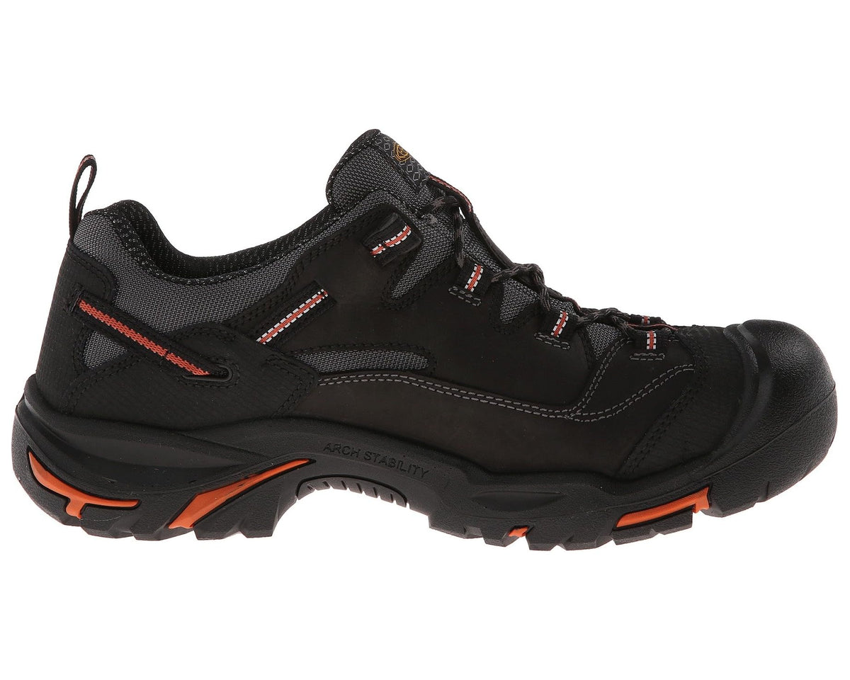 KEEN Braddock Low men's black steel-toe work sneaker, quarter view with orange sole