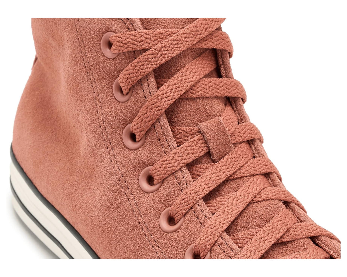Close-up of burnt orange suede high-top laces and eyelets with white and black trim