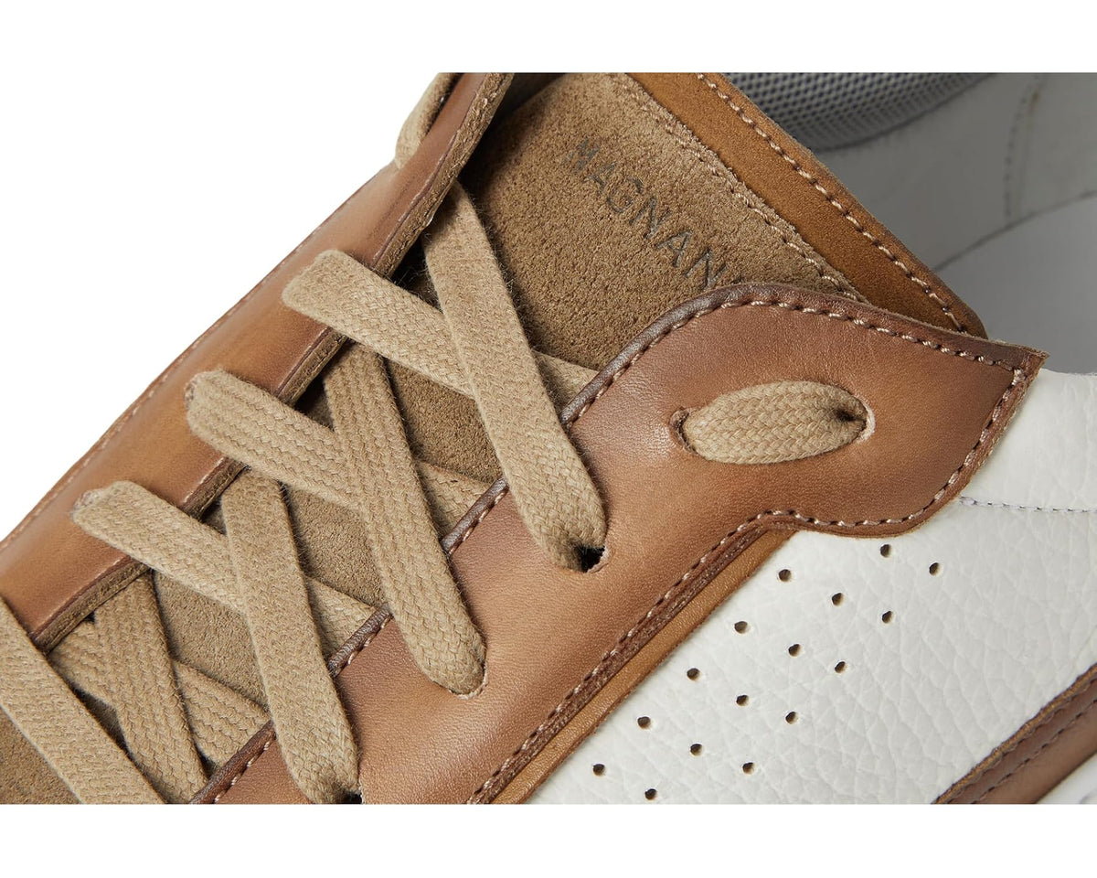 Men's Magnanni lace-up sneaker close-up: tan laces, perforations, and stitched overlays