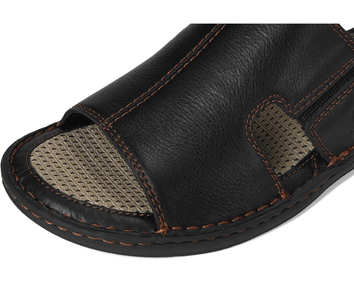 Black leather slide sandal with textured side panel and contrast tan stitching