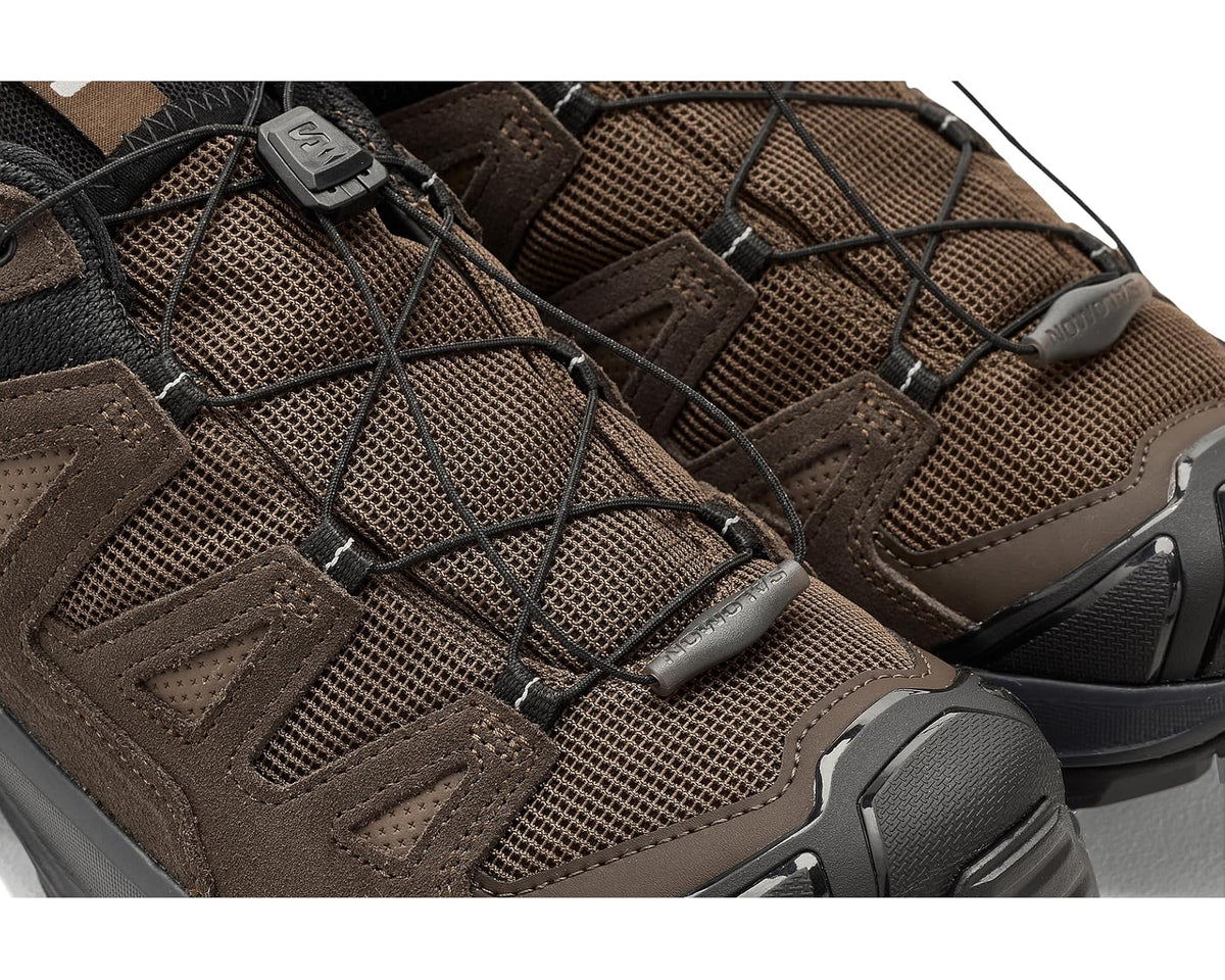Men's Salomon hiking shoe upper close-up, dark earth mesh with protective overlays