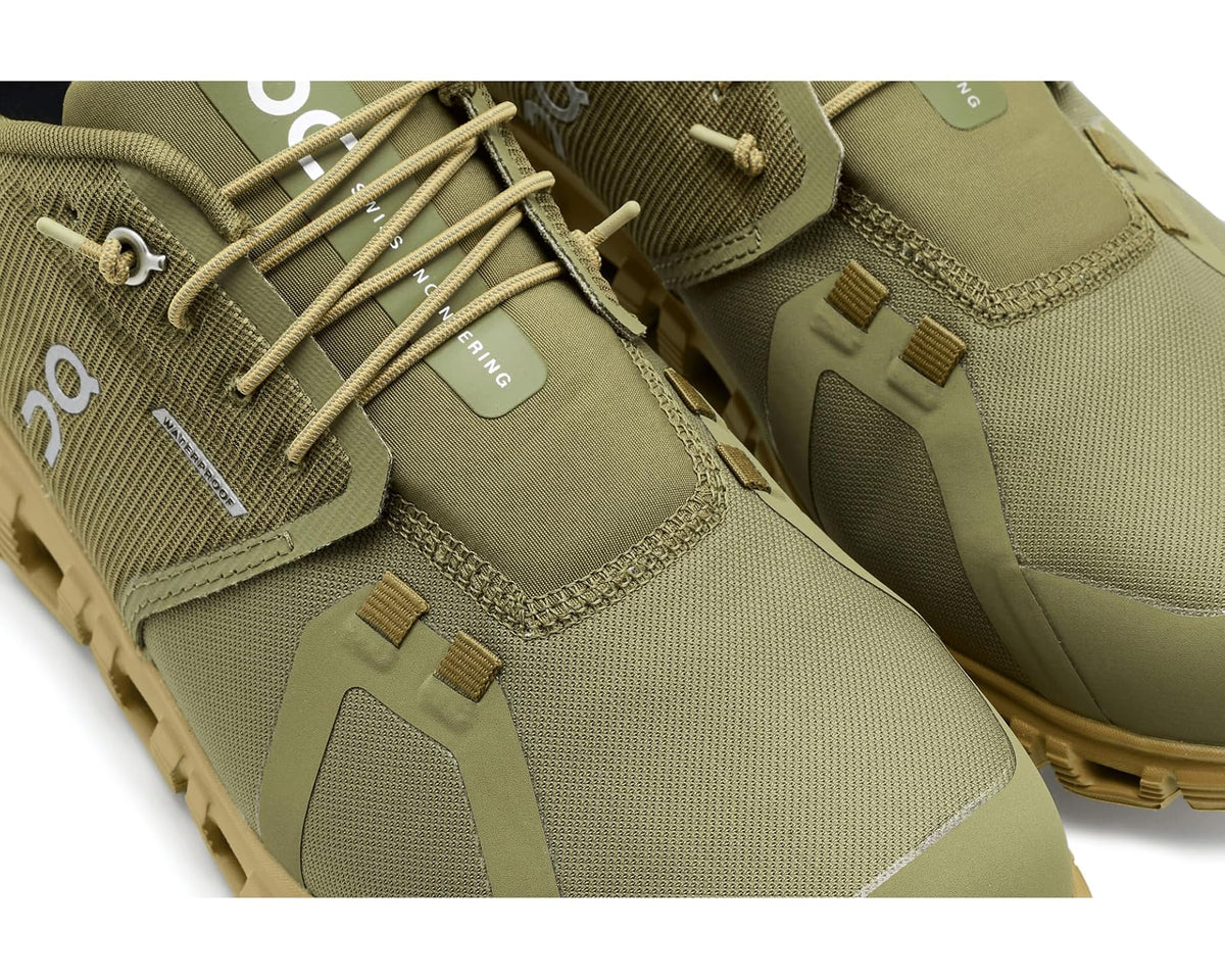 Close-up of men's waterproof olive shoe with laces and textured fabric panels