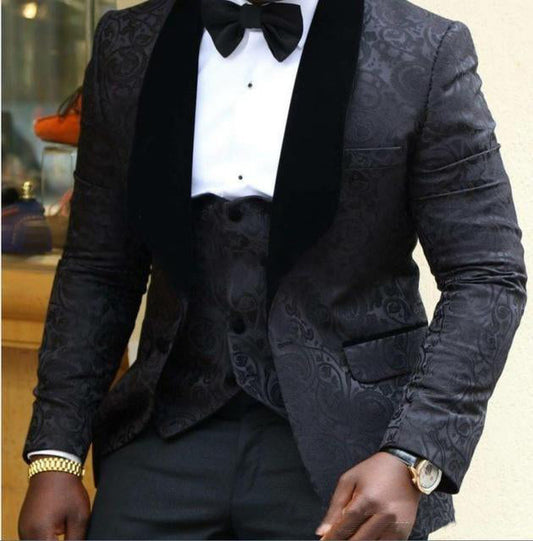 Men's dark patterned tuxedo jacket with black lapels, white shirt, and bow tie