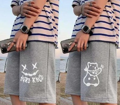 Gray shorts with white skull-crossbones style graphic; second pair has cartoon cat print