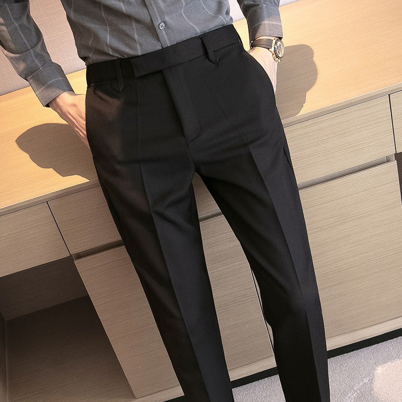 Men's dress pants in black, pleated front with belt loops and straight tapered legs
