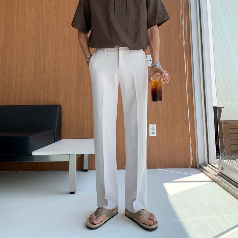 White loose straight trousers with relaxed fit, ankle-length, and front crease